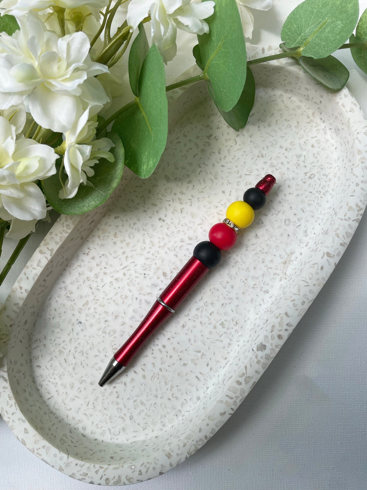 Black, Red and Yellow Pen
